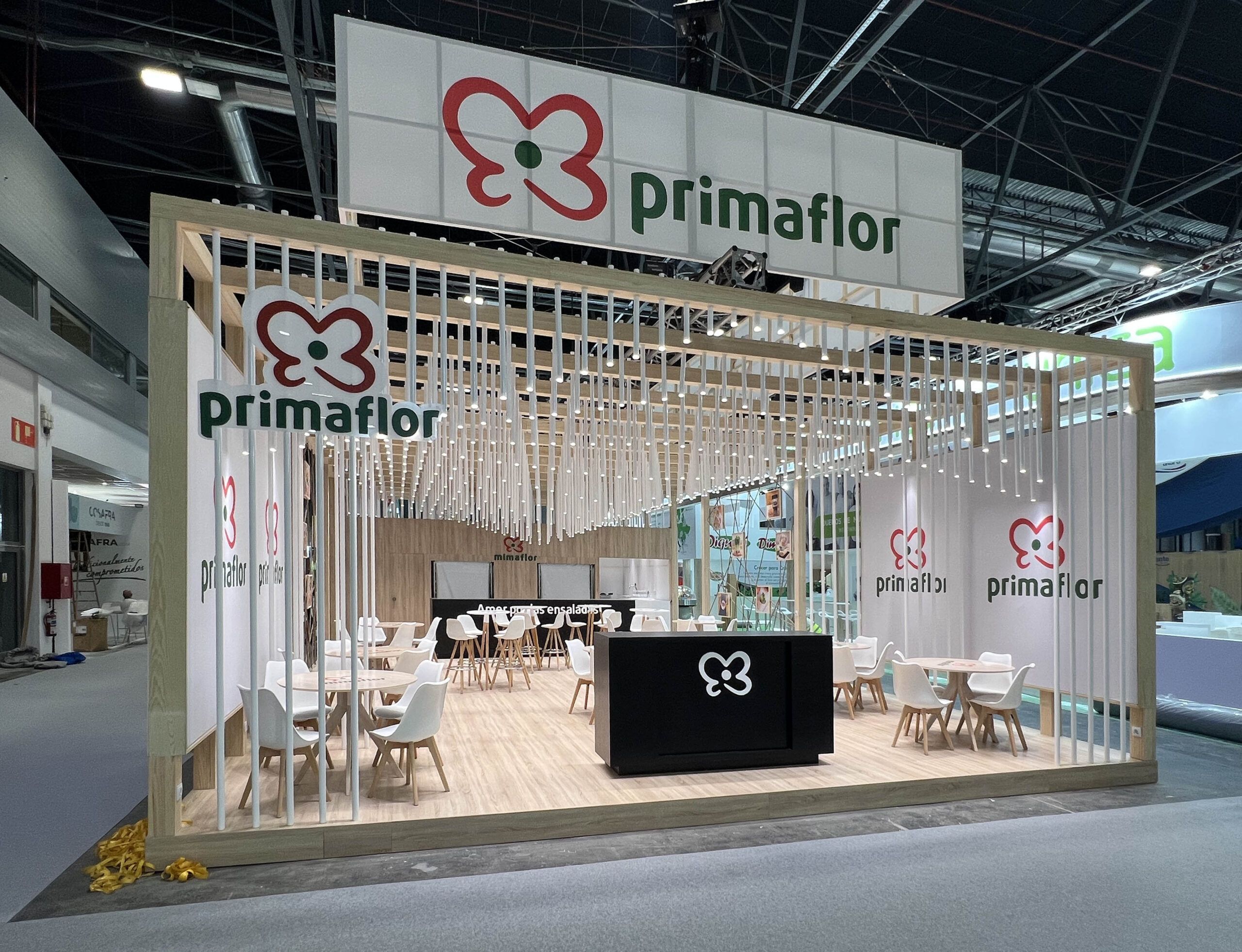 Custom exhibition stand with wooden slats and meeting area at Fruit Attraction Madrid