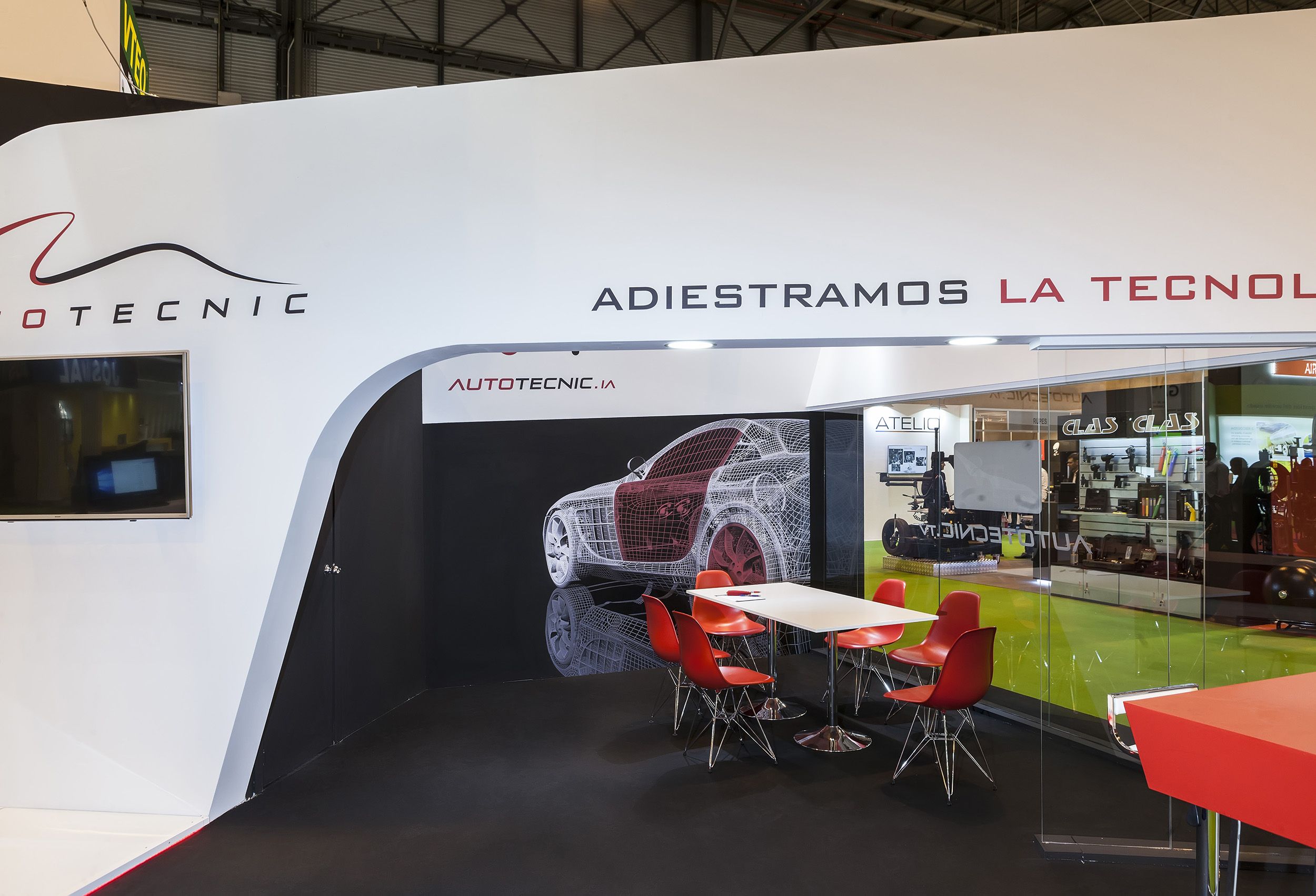Glass meeting room within automotive exhibition stand featuring sleek materials and modern lighting