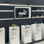 Product display area showcasing sports footwear at a booth in IFEMA