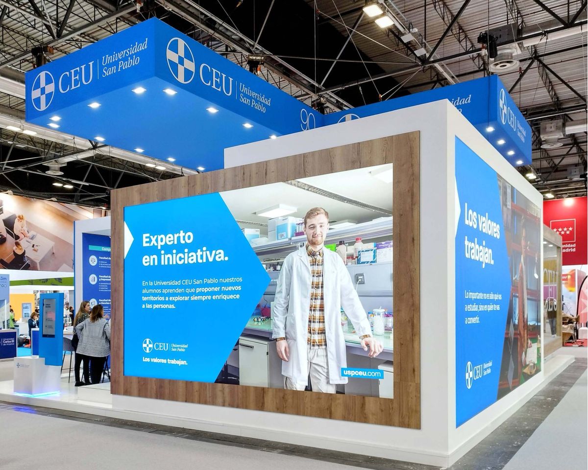 Custom exhibition stand in Madrid with backlit graphics and wood finishes by PG Exhibition Stands