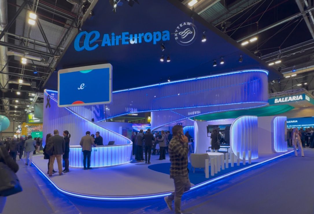 Air Europa stand at FITUR 2026 at IFEMA Madrid with blue lighting and visitors.