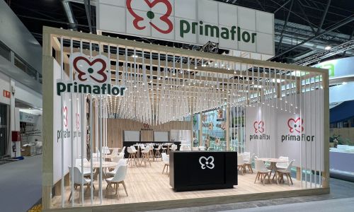 Custom exhibition stand with wooden slats and meeting area at Fruit Attraction Madrid